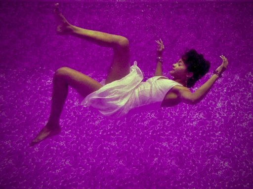 woman falls on purple surface